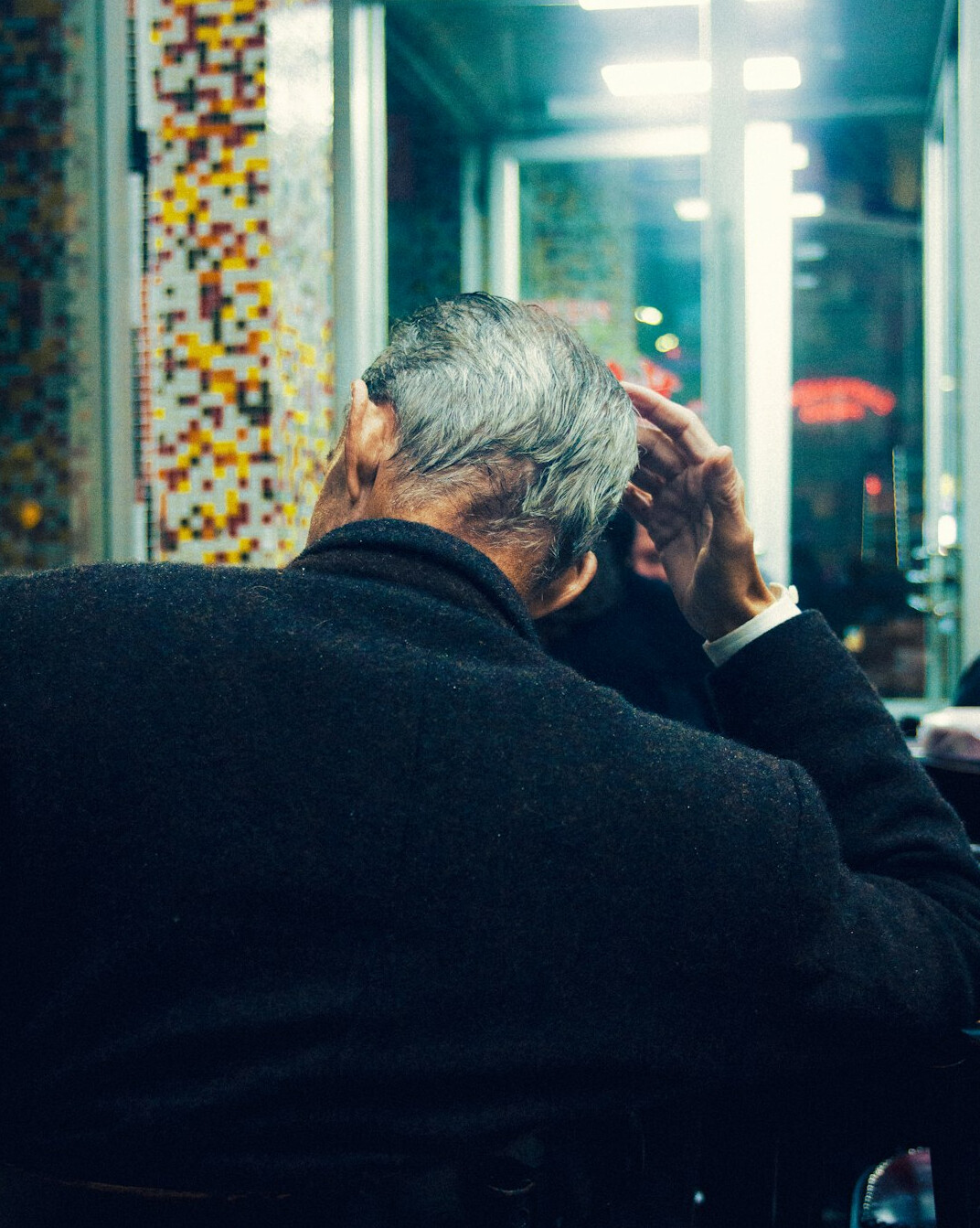 Financial advisor talking with a senior client across a desk
